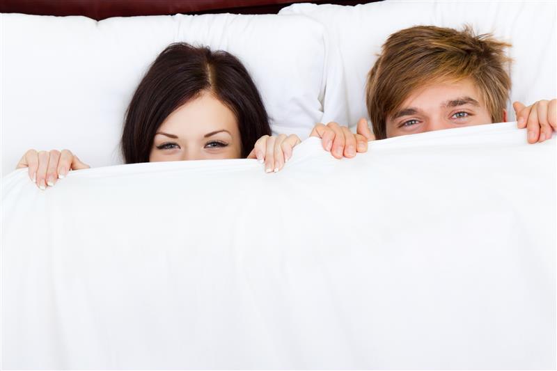 Young Couple Hiding under blanket 