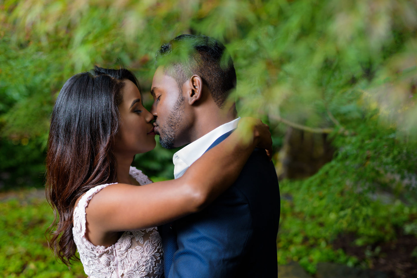 Couple kissing in a green background 