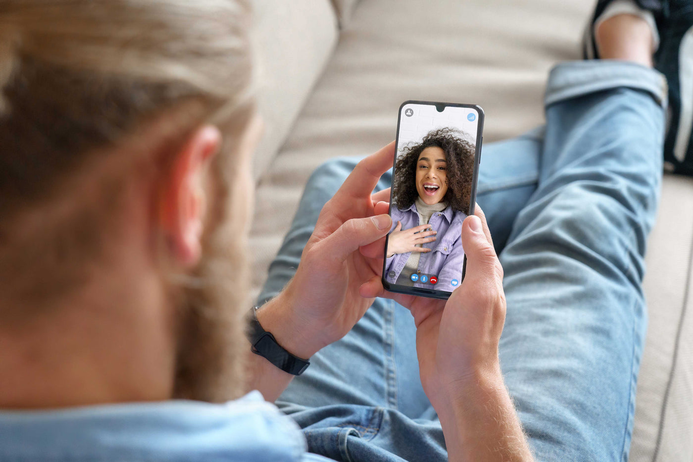man holding phone having face time with girl friend