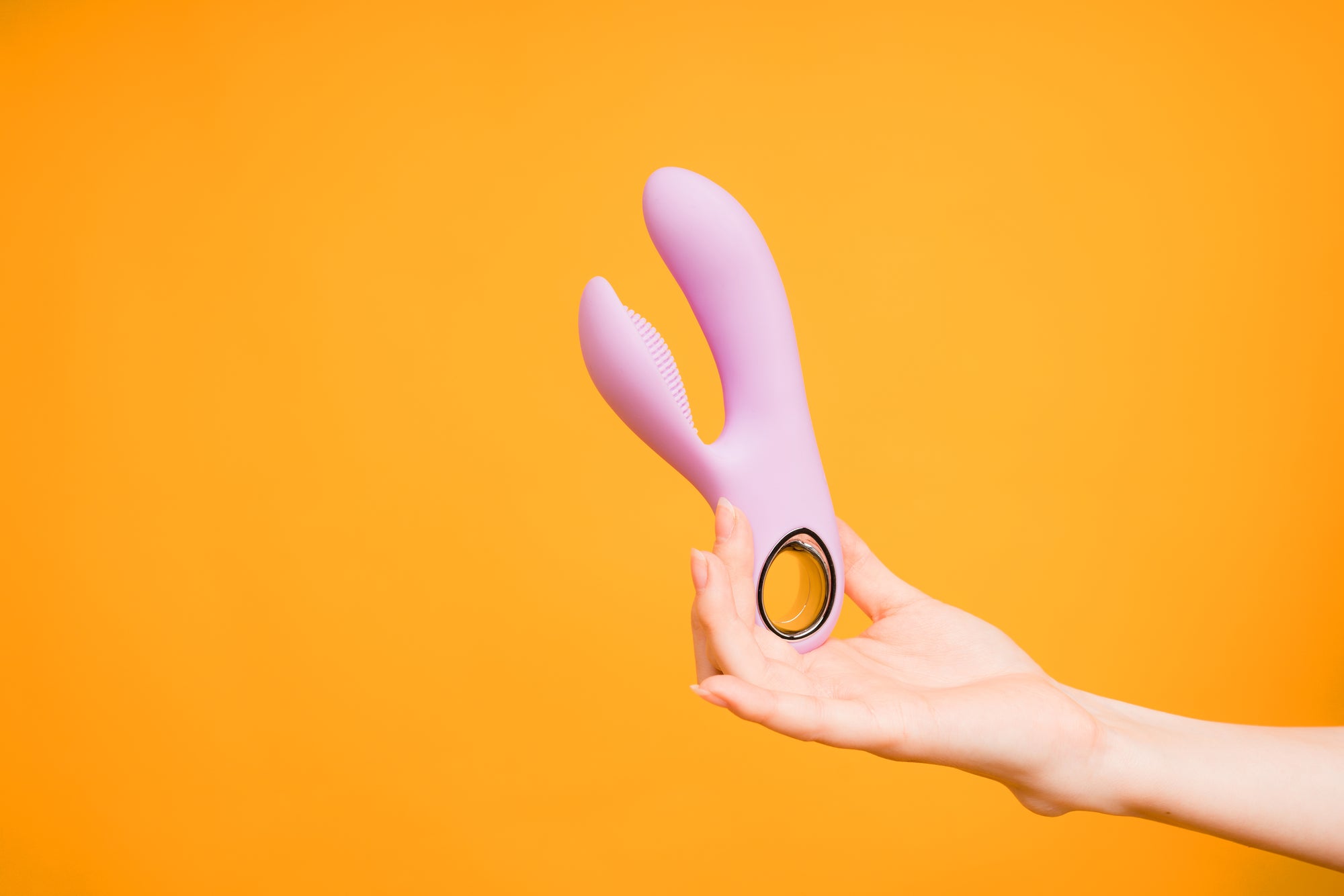 Women holding double vibrator 