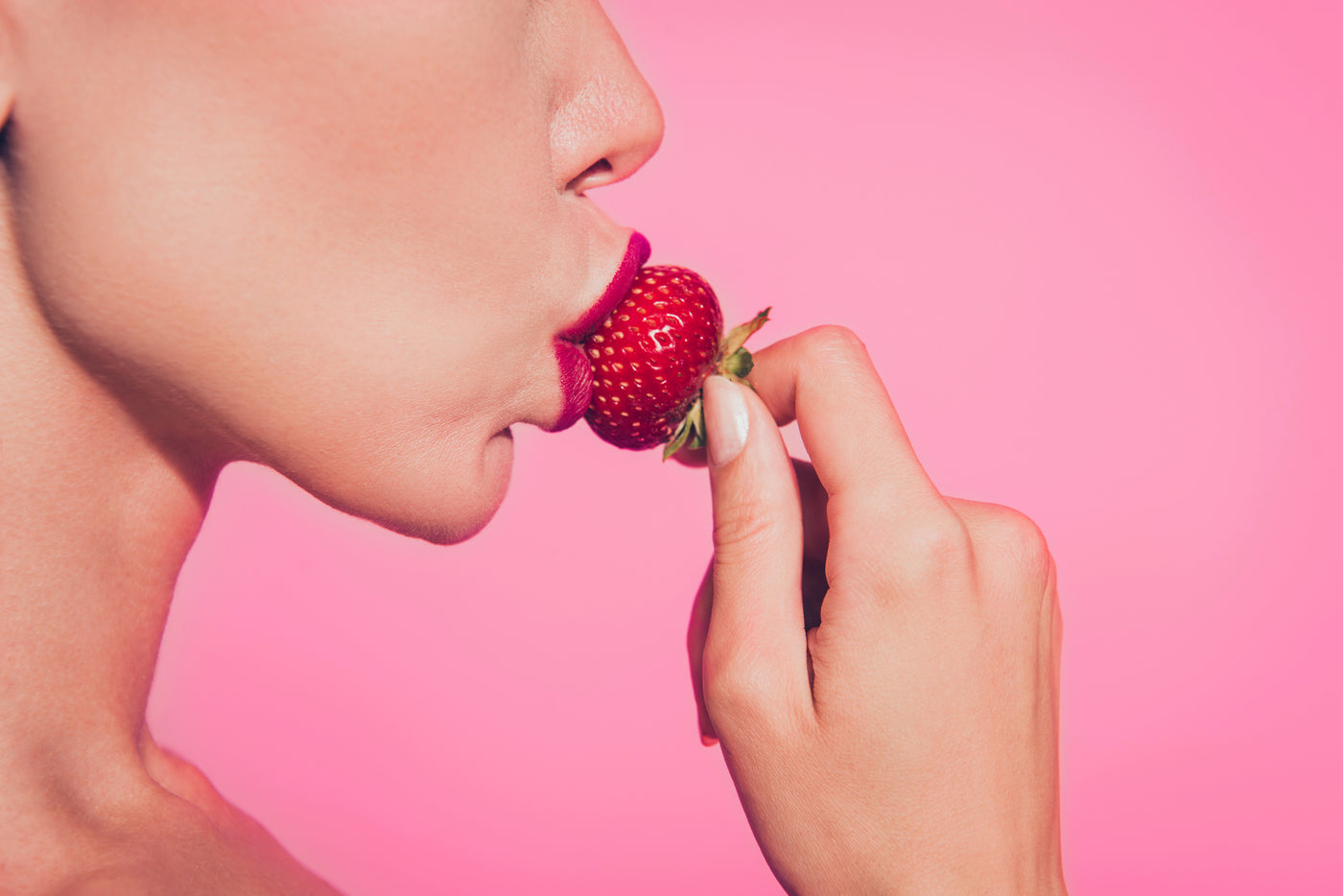Woman about to eat strawberry 